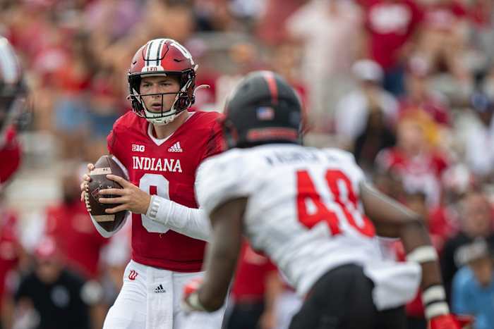 Sep 17, 2022; Bloomington, Indiana, USA; Indiana Hoosiers quarterback Connor Bazelak (9) looks for an open teammate over Western Kentucky Hilltoppers defensive back B.J. Wagner (40) during the second half at Memorial Stadium. Hoosiers won 33 to 30 in overtime. Mandatory Credit: Marc Lebryk-USA TODAY Sports